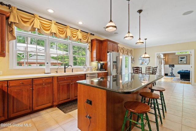 428 Ridgehill Rd, Guilderland, NY 12303 - kitchen with appliances with stainless steel finishes, light tile patterned floors, crown molding, a kitchen island, and plenty of natural light
