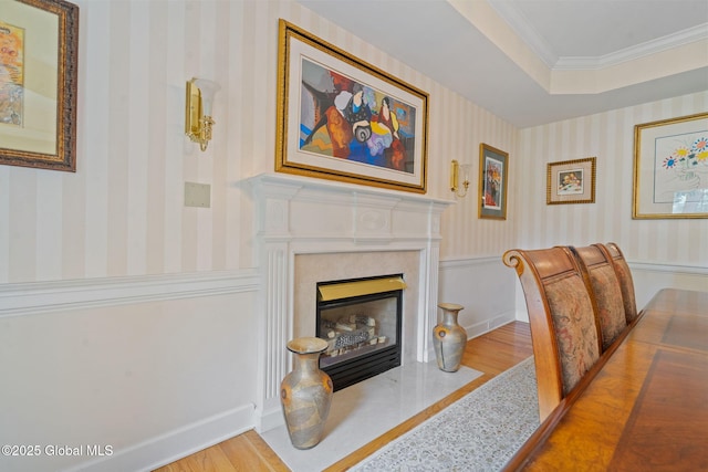 428 Ridgehill Rd, Guilderland, NY 12303 - living area featuring wood finished floors, wallpapered walls, a premium fireplace, and crown molding