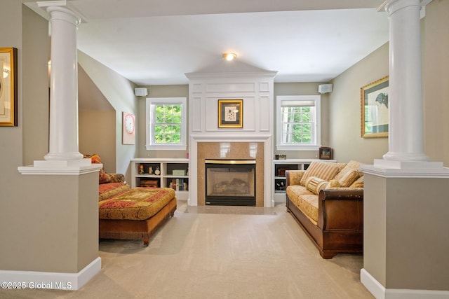 428 Ridgehill Rd, Guilderland, NY 12303 - living room with ornate columns, healthy amount of natural light, light colored carpet, and a high end fireplace