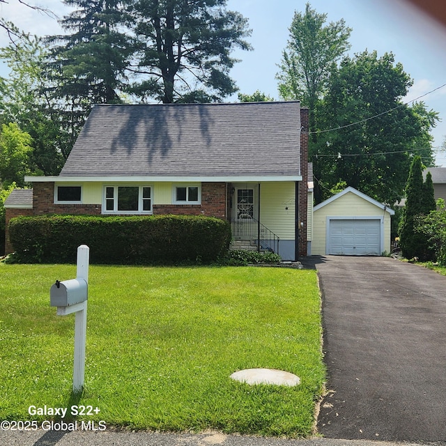 27 Emery Ave, Colonie, NY 12205 - cape cod house with an outdoor structure, asphalt driveway, a detached garage, a front lawn, and brick siding