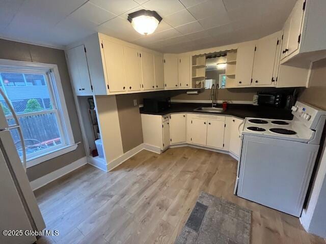 27 Emery Ave, Colonie, NY 12205 - kitchen featuring white appliances, open shelves, light wood-type flooring, dark countertops, and white cabinets