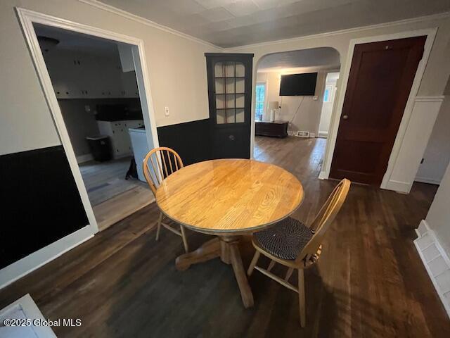 27 Emery Ave, Colonie, NY 12205 - dining area featuring arched walkways, wood finished floors, and ornamental molding