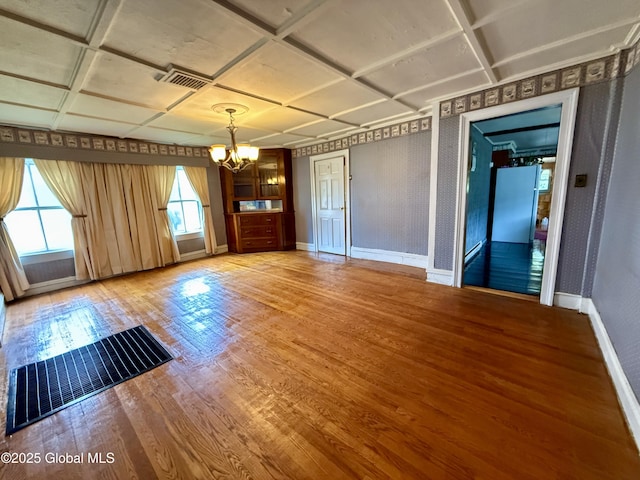252 Main St, Hudson Falls, NY 12839 - empty room featuring a chandelier, light wood-style floors, and coffered ceiling