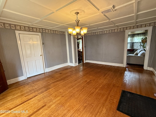 252 Main St, Hudson Falls, NY 12839 - unfurnished dining area featuring a chandelier, wood finished floors, and an ornate ceiling