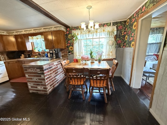252 Main St, Hudson Falls, NY 12839 - dining space featuring wallpapered walls, a chandelier, dark wood-style floors, and ornamental molding