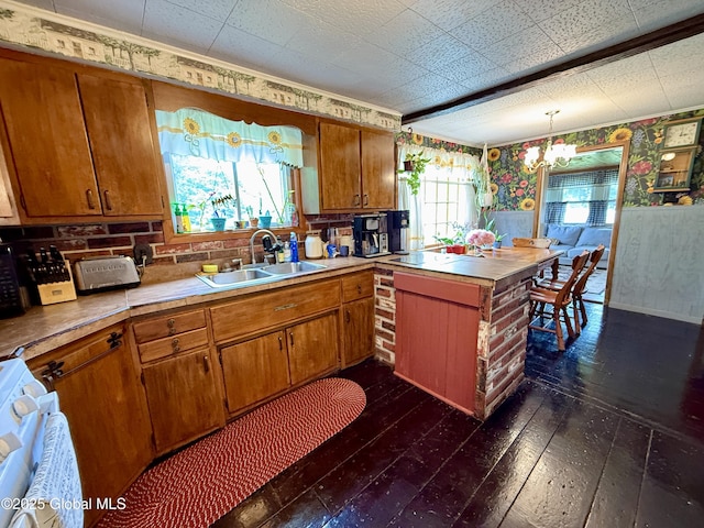 252 Main St, Hudson Falls, NY 12839 - kitchen featuring stove, wallpapered walls, dark wood finished floors, brown cabinets, and plenty of natural light