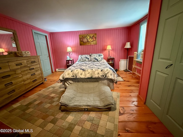 252 Main St, Hudson Falls, NY 12839 - bedroom with light wood finished floors and a baseboard heating unit