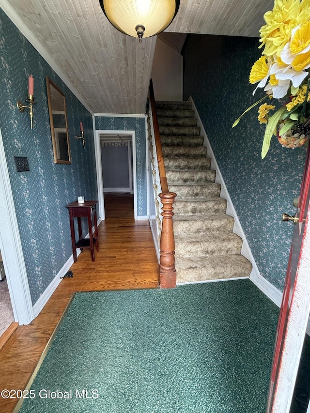 252 Main St, Hudson Falls, NY 12839 - stairs with wallpapered walls, wood finished floors, and wooden ceiling