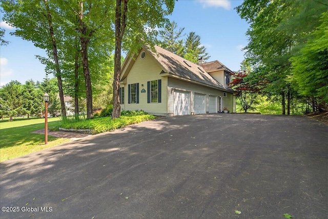 460 Grand Ave, Saratoga Springs, NY 12866 - view of front facade featuring asphalt driveway and a garage
