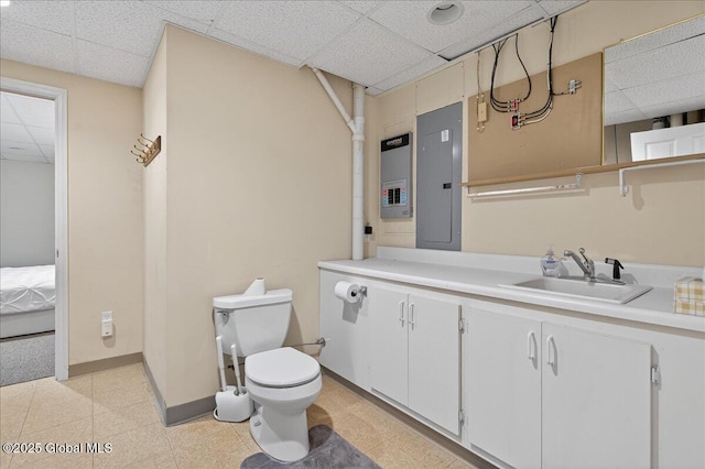 460 Grand Ave, Saratoga Springs, NY 12866 - bathroom featuring a paneled ceiling, electric panel, vanity, and ensuite bath