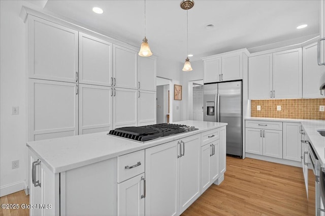 460 Grand Ave, Saratoga Springs, NY 12866 - kitchen featuring stainless steel appliances, a center island, white cabinets, light wood-type flooring, and recessed lighting