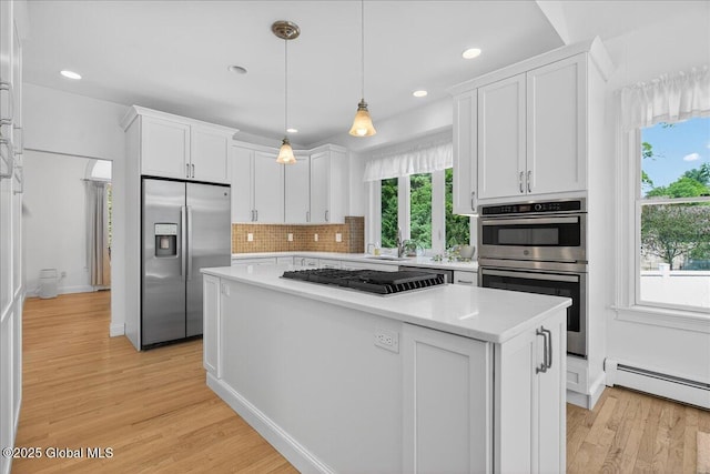 460 Grand Ave, Saratoga Springs, NY 12866 - kitchen featuring stainless steel appliances, a baseboard radiator, light wood-style flooring, white cabinetry, and light countertops