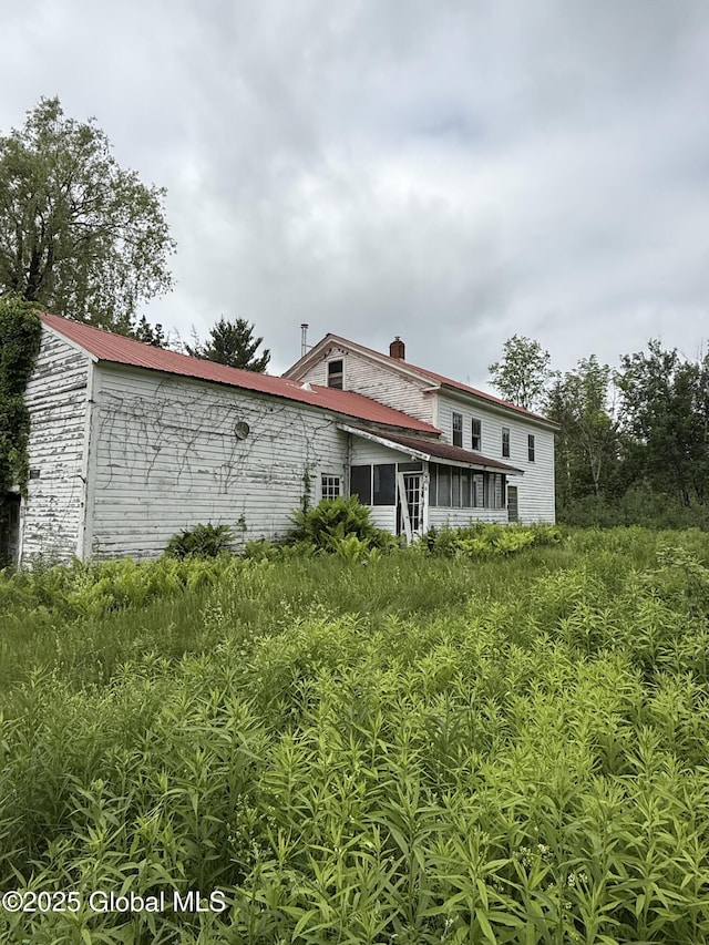 59 Lagrange Rd, Crown Point, NY 12928 - rear view of house with a sunroom and a chimney