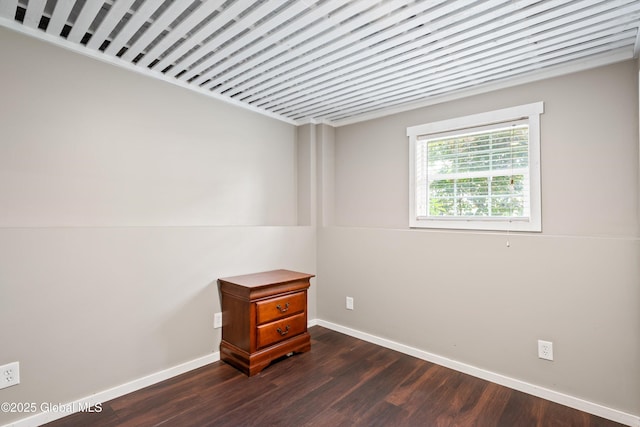 30 W State St, Glens Falls, NY 12801 - spare room featuring baseboards and dark wood-type flooring