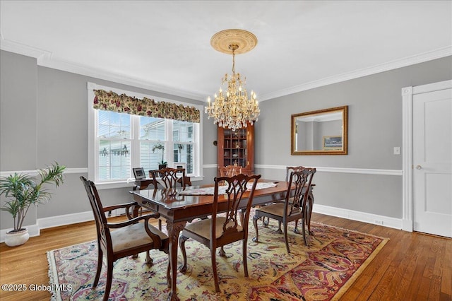 479 Loudon Rd, Colonie, NY 12211 - dining space featuring a chandelier, crown molding, and wood finished floors