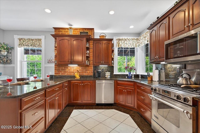 479 Loudon Rd, Colonie, NY 12211 - kitchen featuring appliances with stainless steel finishes, a peninsula, backsplash, healthy amount of natural light, and recessed lighting