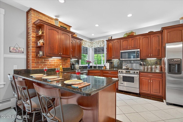 479 Loudon Rd, Colonie, NY 12211 - kitchen featuring stainless steel appliances, a peninsula, backsplash, a kitchen bar, and recessed lighting