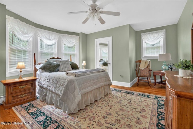 479 Loudon Rd, Colonie, NY 12211 - bedroom with multiple windows, light wood-style floors, and a ceiling fan