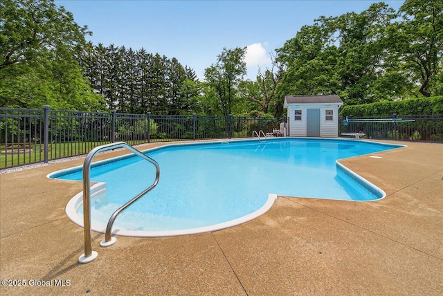 479 Loudon Rd, Colonie, NY 12211 - view of swimming pool featuring a patio area, view of wooded area, and a shed