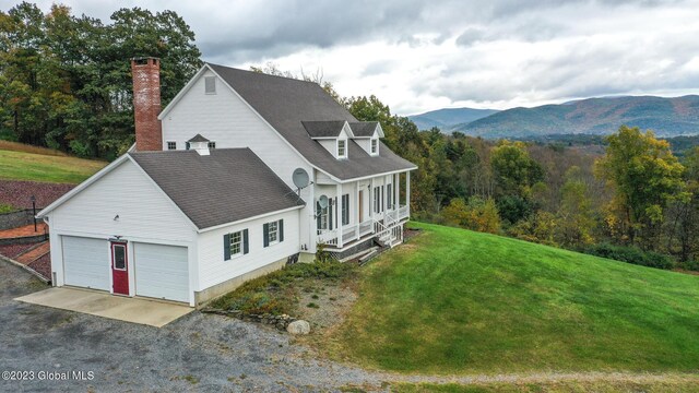 42 Stanton Rd, Jackson, NY 12873 - view of home's exterior featuring a lawn, a chimney, a porch, a mountain view, and roof with shingles