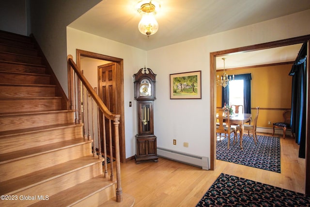 42 Stanton Rd, Jackson, NY 12873 - staircase featuring a baseboard radiator, wood finished floors, and a chandelier