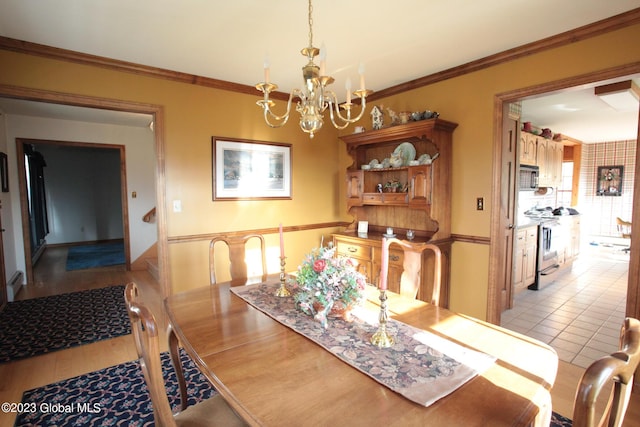 42 Stanton Rd, Jackson, NY 12873 - tiled dining room with a chandelier and crown molding
