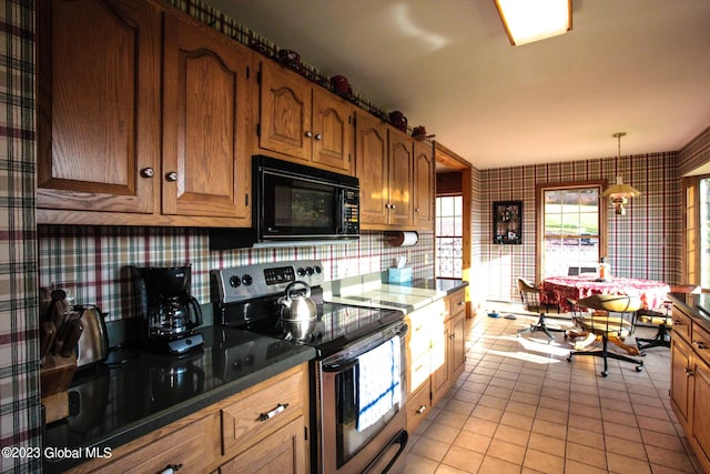 42 Stanton Rd, Jackson, NY 12873 - kitchen with electric range, wallpapered walls, black microwave, light tile patterned floors, and brown cabinets