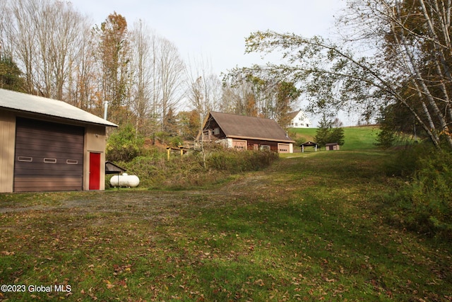 42 Stanton Rd, Jackson, NY 12873 - view of green lawn with an outdoor structure and a garage
