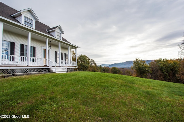 42 Stanton Rd, Jackson, NY 12873 - view of grassy yard with covered porch and a mountain view