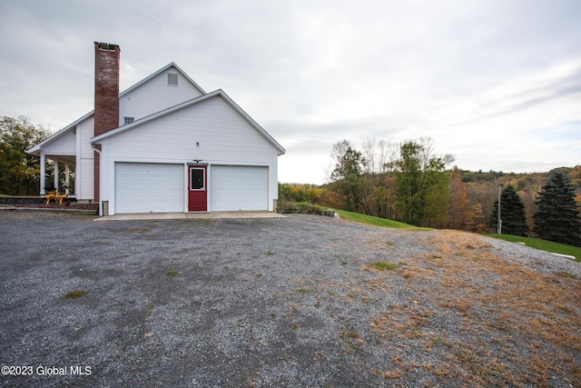 42 Stanton Rd, Jackson, NY 12873 - view of side of home with a chimney and a garage