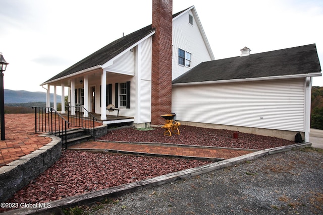 42 Stanton Rd, Jackson, NY 12873 - view of property exterior with a chimney, a porch, and a mountain view