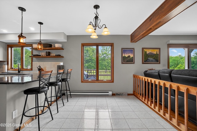 1560 Division St, Charlton, NY 12010 - dining room with a baseboard heating unit, beamed ceiling, light tile patterned floors, and a chandelier