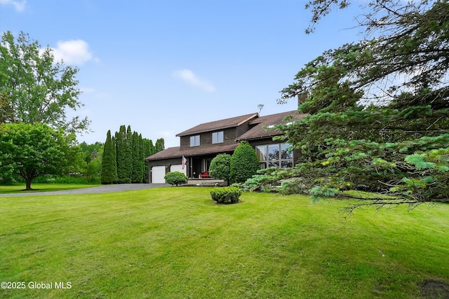 1560 Division St, Charlton, NY 12010 - view of front facade featuring asphalt driveway, a front lawn, and an attached garage