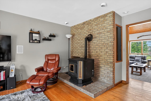 1560 Division St, Charlton, NY 12010 - living room with wood finished floors and a wood stove