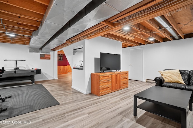 1560 Division St, Charlton, NY 12010 - living area featuring light wood-type flooring and a baseboard radiator