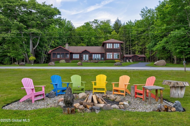 555 Trout Lake Rd, Bolton, NY 12824 - view of green lawn with an outdoor fire pit