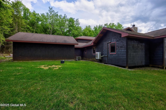 555 Trout Lake Rd, Bolton, NY 12824 - back of house with a chimney, a lawn, and a shingled roof