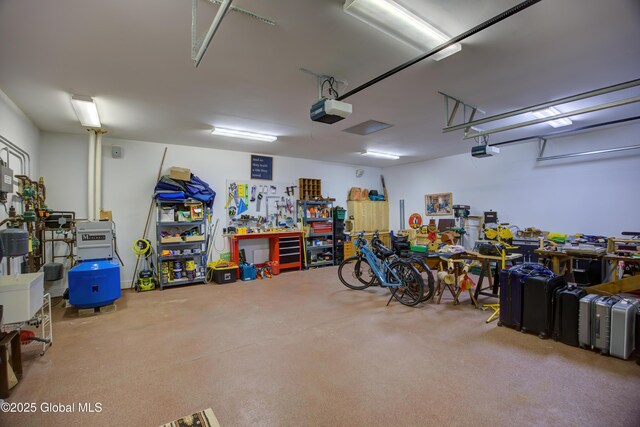 555 Trout Lake Rd, Bolton, NY 12824 - garage featuring a garage door opener and a workshop area