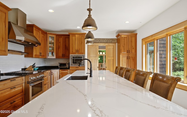 555 Trout Lake Rd, Bolton, NY 12824 - kitchen featuring wall chimney exhaust hood, appliances with stainless steel finishes, tasteful backsplash, hanging light fixtures, and recessed lighting