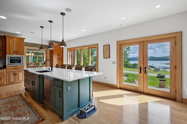 555 Trout Lake Rd, Bolton, NY 12824 - kitchen featuring french doors, recessed lighting, light wood-type flooring, a kitchen island with sink, and hanging light fixtures