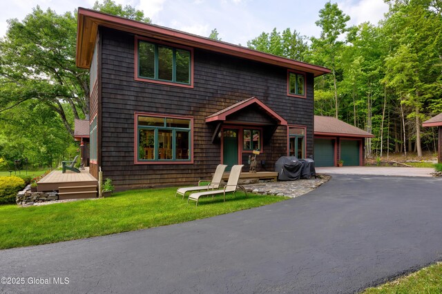 555 Trout Lake Rd, Bolton, NY 12824 - view of front of home with a front yard, a wooden deck, and driveway