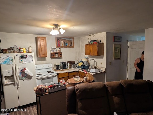 312 Ridge Rd, Northampton, NY 12134 - kitchen featuring white appliances, wood finished floors, and brown cabinetry