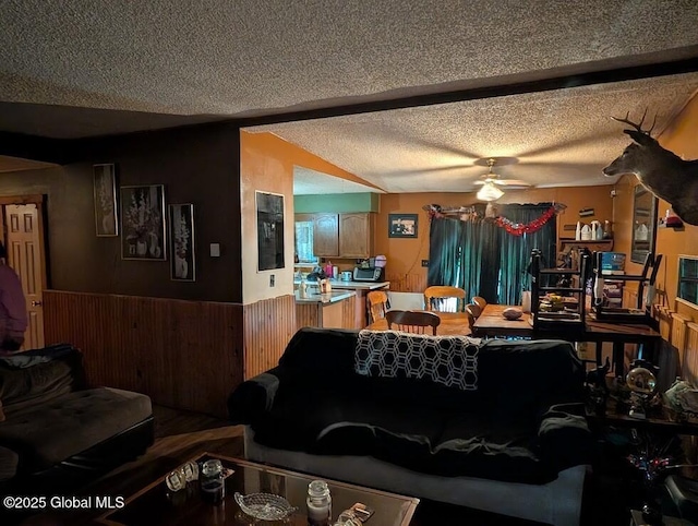 312 Ridge Rd, Northampton, NY 12134 - living area with a textured ceiling, ceiling fan, wainscoting, and wooden walls