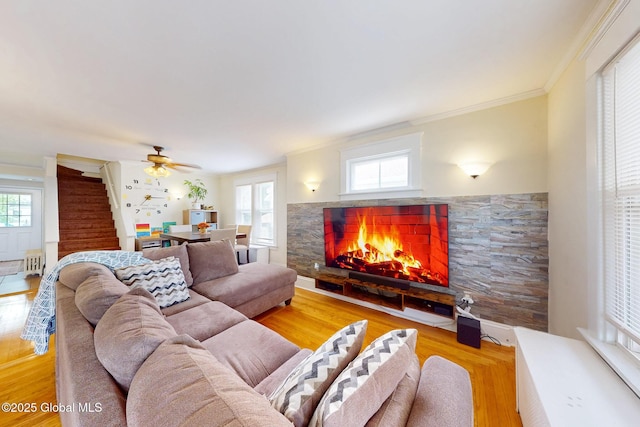66 Roosevelt Ave, Schenectady, NY 12304 - living area with a stone fireplace, wood finished floors, ceiling fan, and ornamental molding