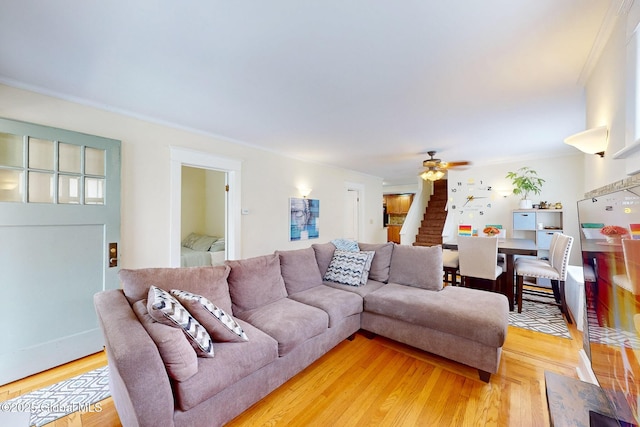66 Roosevelt Ave, Schenectady, NY 12304 - living room featuring light wood-style flooring, ceiling fan, crown molding, and stairs
