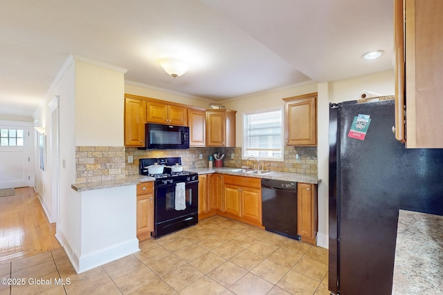 66 Roosevelt Ave, Schenectady, NY 12304 - kitchen with black appliances, healthy amount of natural light, crown molding, and tasteful backsplash