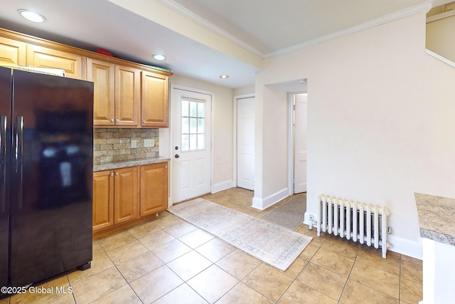 66 Roosevelt Ave, Schenectady, NY 12304 - kitchen featuring freestanding refrigerator, radiator heating unit, ornamental molding, decorative backsplash, and light tile patterned flooring