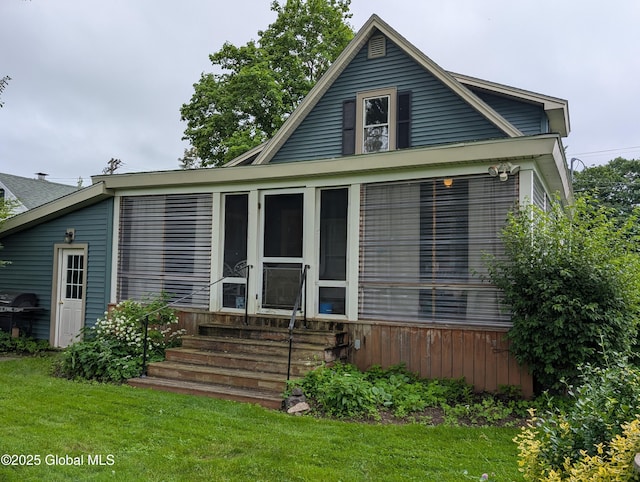19 High St, Fort Plain, NY 13339 - bungalow-style house featuring entry steps, a front lawn, and a sunroom
