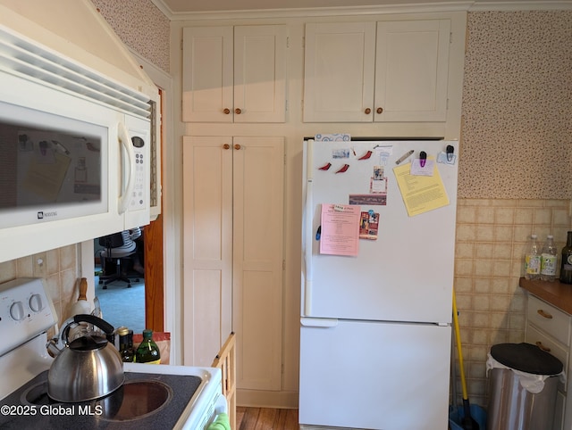 19 High St, Fort Plain, NY 13339 - kitchen featuring white appliances, wallpapered walls, and white cabinets