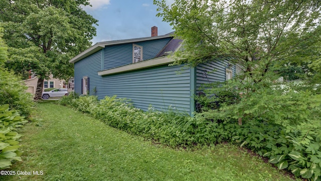 19 High St, Fort Plain, NY 13339 - view of home's exterior with a chimney and a yard